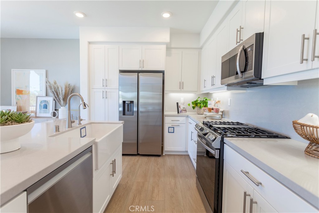 18646 Rorimer Street La Puente, CA 91744 - Photo 8 of 24 a kitchen with stainless steel appliances a sink stove and refrigerator
