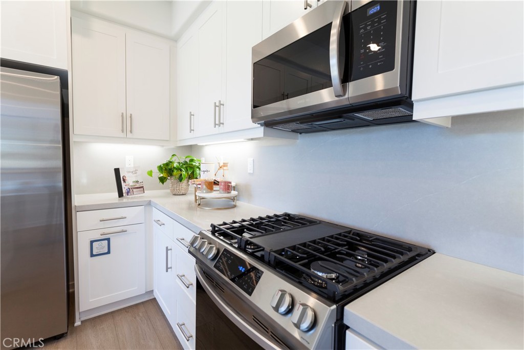 18646 Rorimer Street La Puente, CA 91744 - Photo 9 of 24 a stove top oven sitting inside of a kitchen