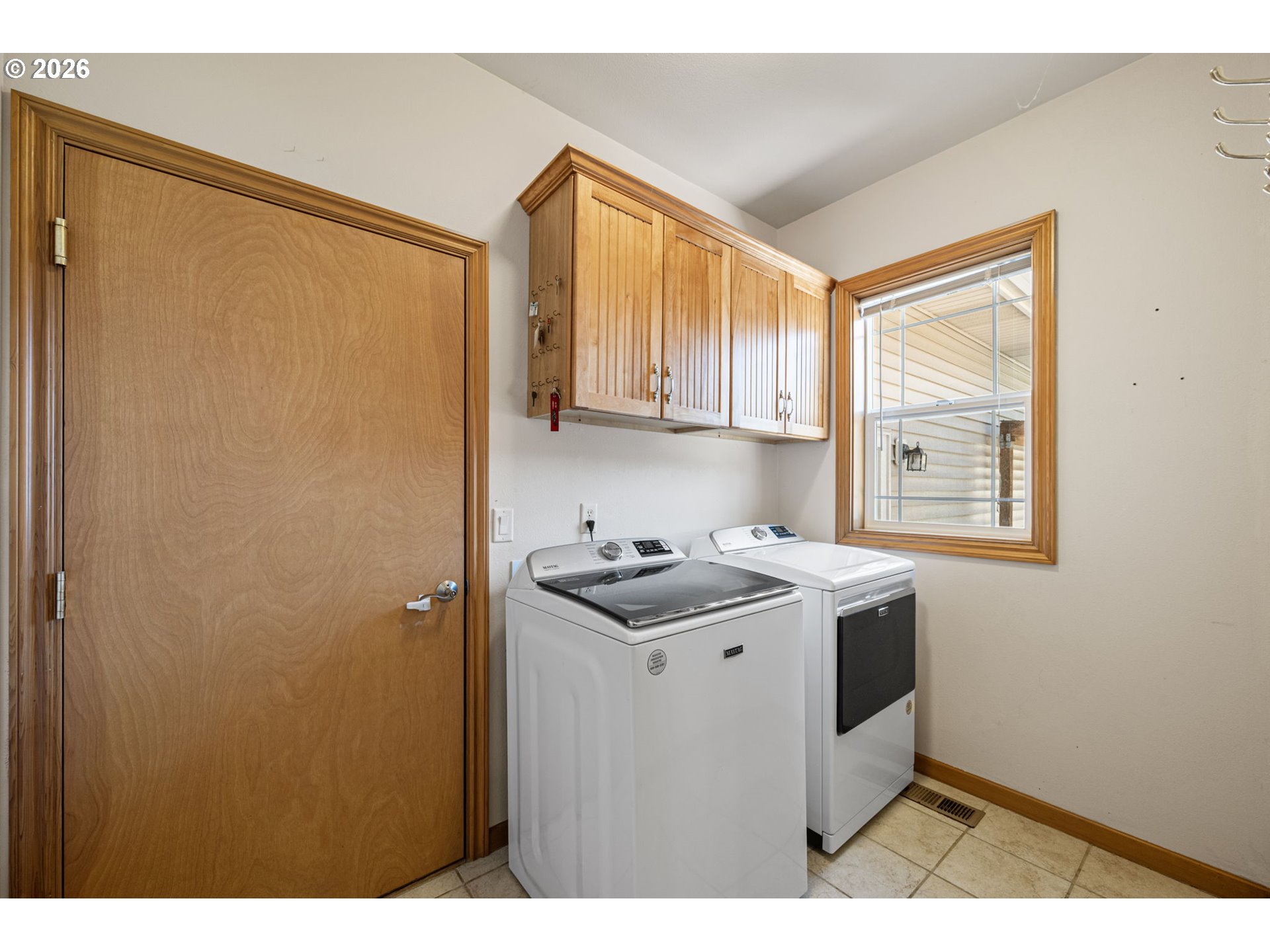 2218 Willow Loop Florence, OR 97439 - Photo 35 of 47 a utility room with a sink a cabinetry and a window