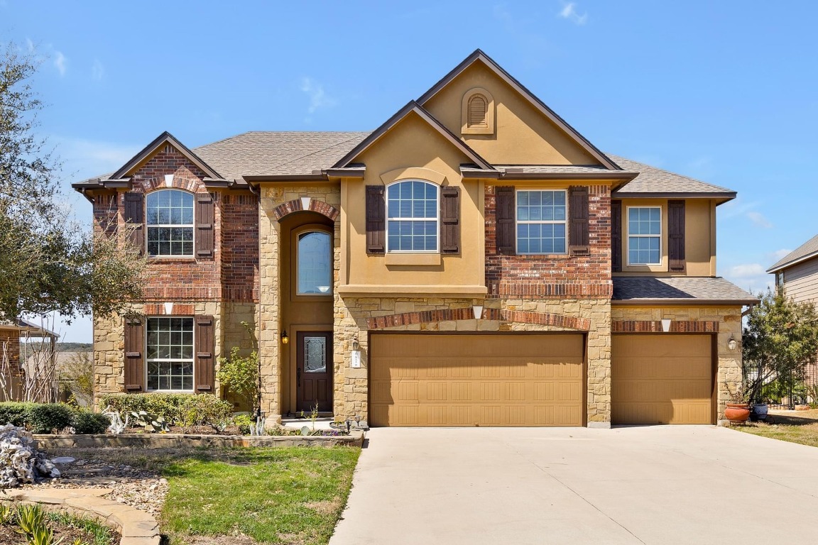 687 Ledge Stone Drive Austin, TX 78737 - Photo 1 of 39 a front view of a house with a yard