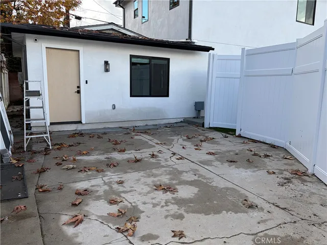 a view of a house with a wooden bench