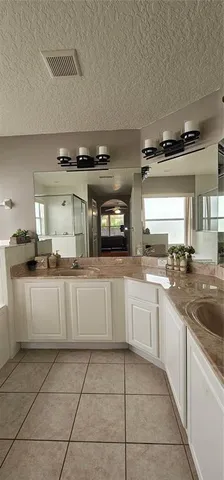 a bathroom with sinks mirror and vanity