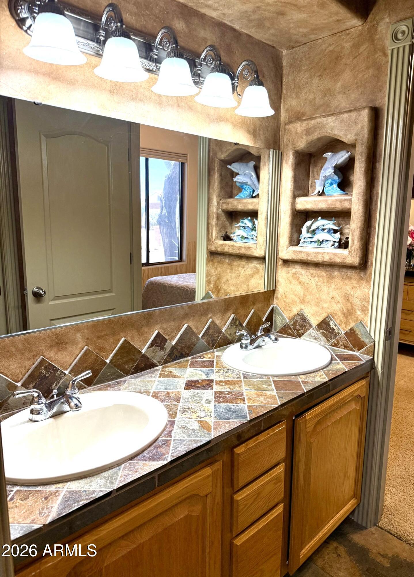 6334 East Albany Street Mesa, AZ 85205 - Photo 36 of 72 a bathroom with a granite countertop sink and a mirror