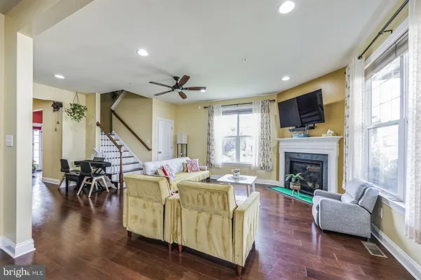 a living room with furniture fireplace and flat screen tv