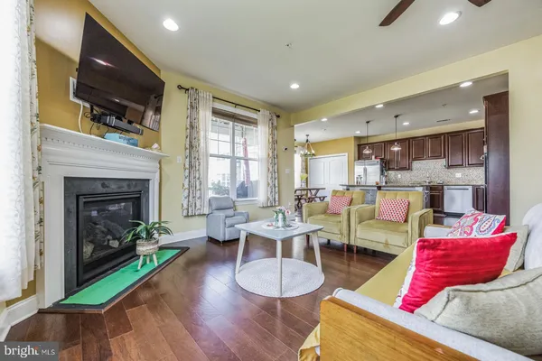 a living room with furniture fireplace and flat screen tv