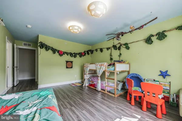 a bedroom with bed and a chandelier