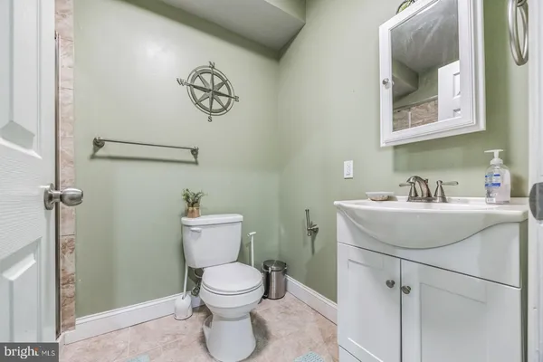 a bathroom with a sink mirror and toilet