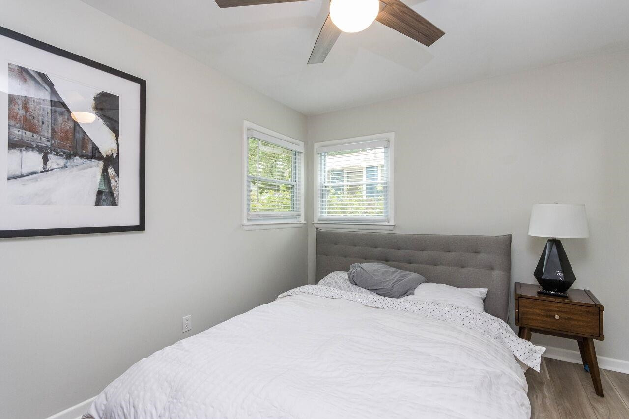 1415 Berkeley Street Durham, NC 27705 - Photo 11 of 24 a bedroom with a bed and wooden floor