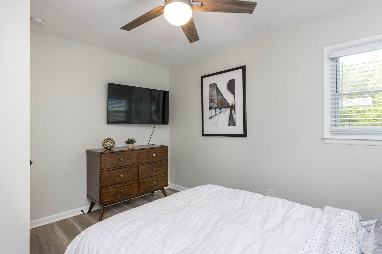 1415 Berkeley Street Durham, NC 27705 - Photo 13 of 24 a bedroom with a bed and a flat screen tv