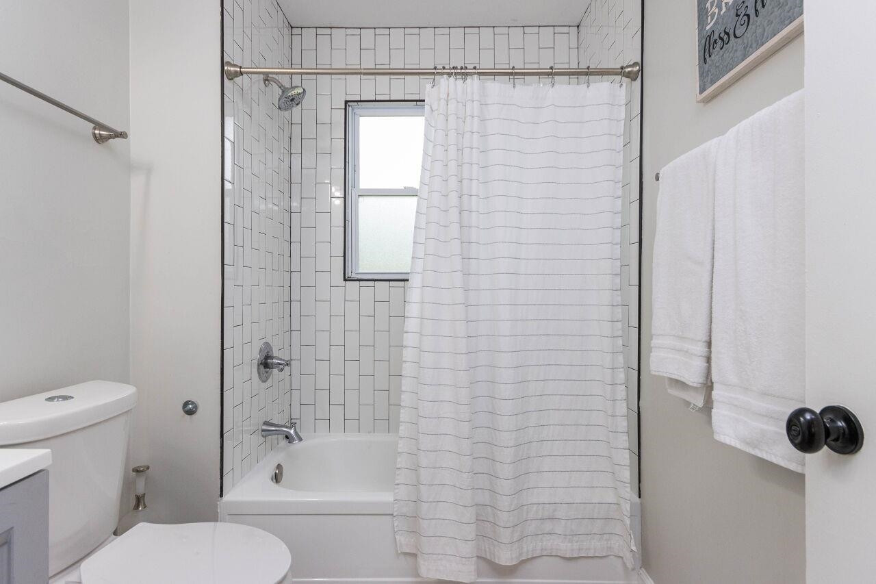 1415 Berkeley Street Durham, NC 27705 - Photo 14 of 24 a bathroom with a toilet and shower