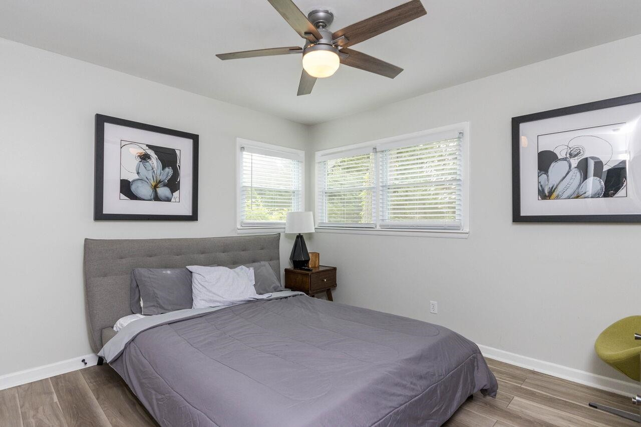 1415 Berkeley Street Durham, NC 27705 - Photo 16 of 24 a bedroom with a bed and a chandelier
