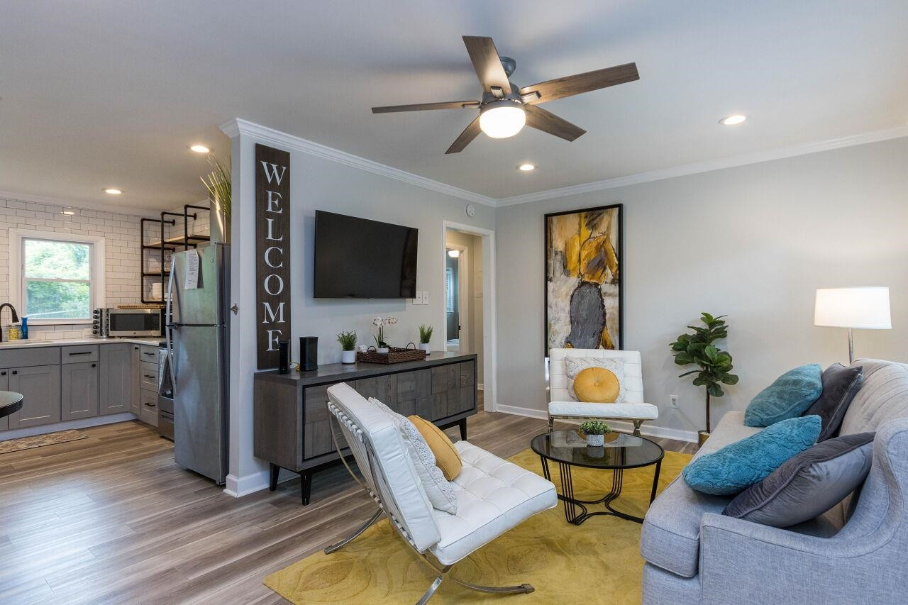 1415 Berkeley Street Durham, NC 27705 - Photo 3 of 24 a living room with furniture and a flat screen tv