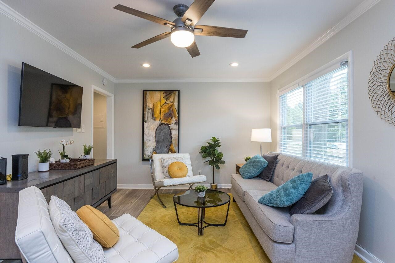 1415 Berkeley Street Durham, NC 27705 - Photo 5 of 24 a living room with furniture and a flat screen tv