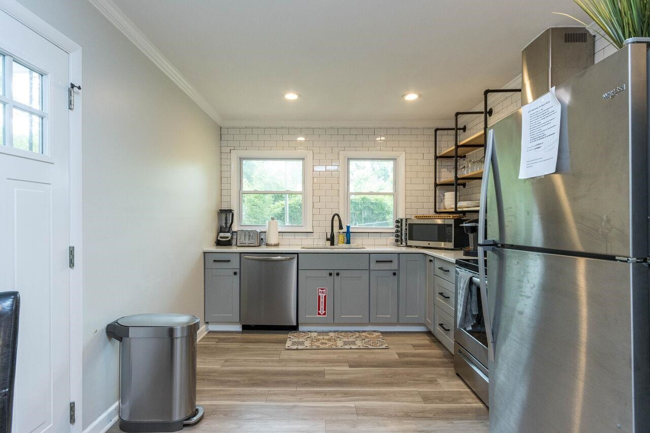 1415 Berkeley Street Durham, NC 27705 - Photo 8 of 24 a kitchen with a refrigerator sink and stove