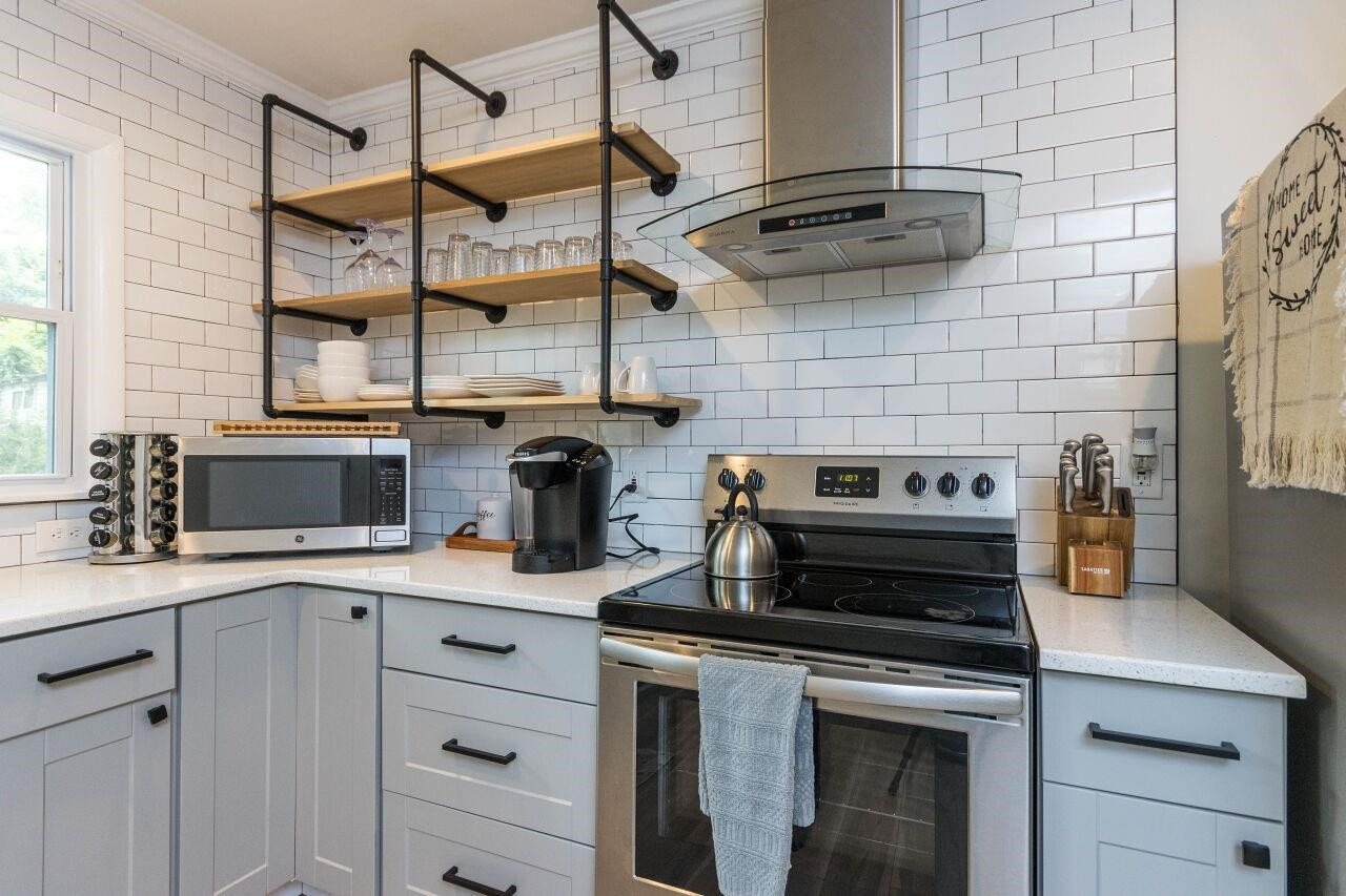 1415 Berkeley Street Durham, NC 27705 - Photo 10 of 24 a kitchen with a stove and a sink