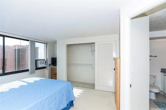 a bedroom with a bed and a dresser