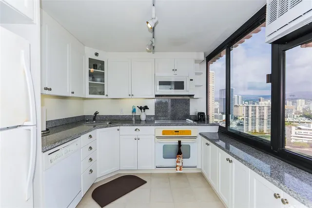 a kitchen with a sink a stove and cabinets