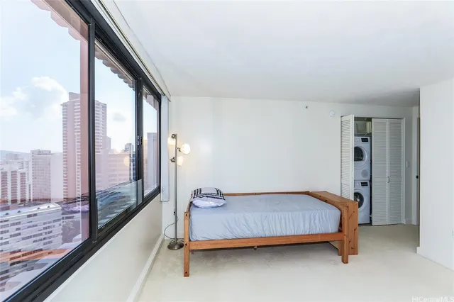 a bedroom with a bed and large window