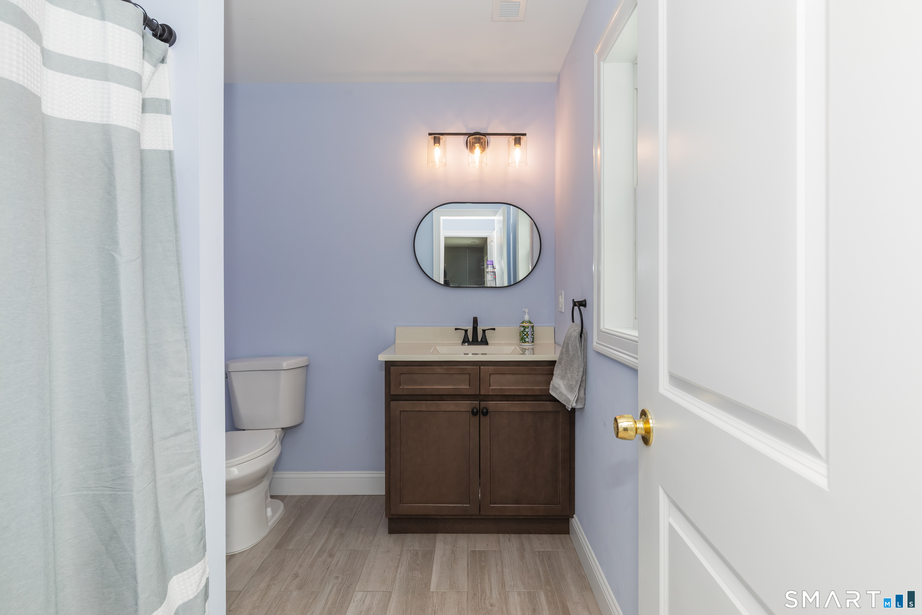 23 North Street Wolcott, CT 06716 - Photo 27 of 30 a bathroom with a sink a toilet and mirror