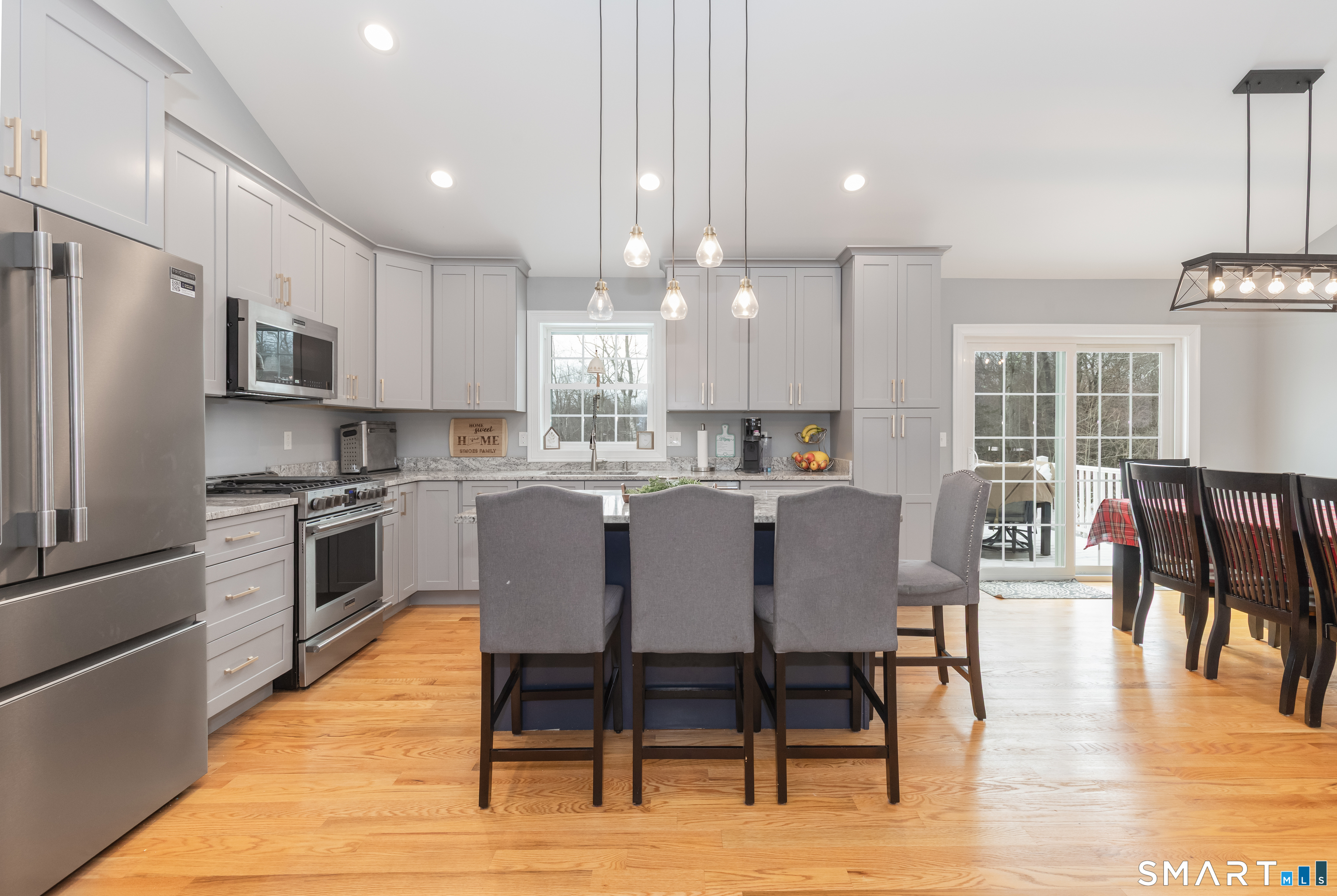 23 North Street Wolcott, CT 06716 - Photo 6 of 30 a kitchen with stainless steel appliances kitchen island granite countertop a dining table chairs refrigerator and sink