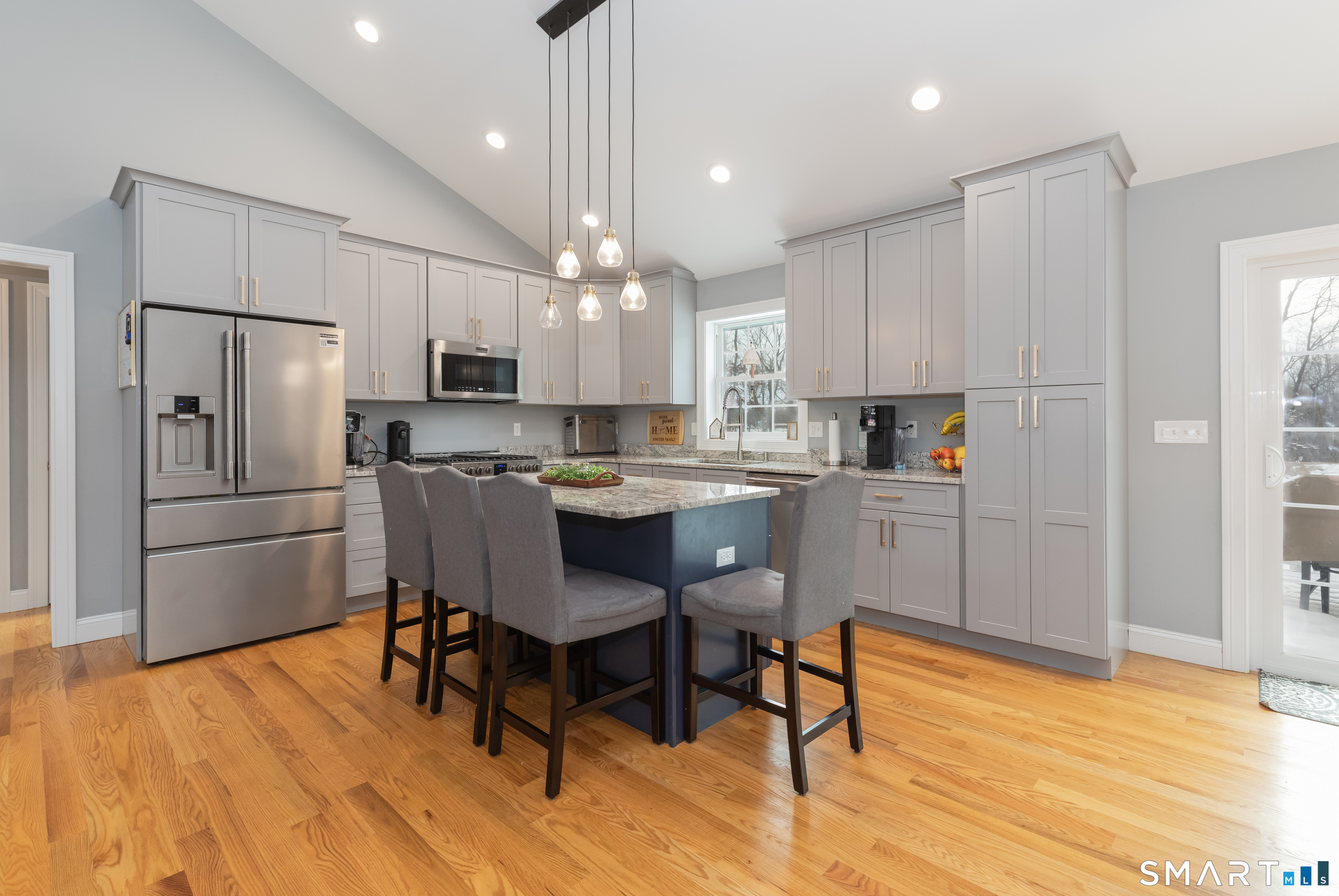 23 North Street Wolcott, CT 06716 - Photo 8 of 30 a kitchen with stainless steel appliances a dining table chairs refrigerator microwave and sink