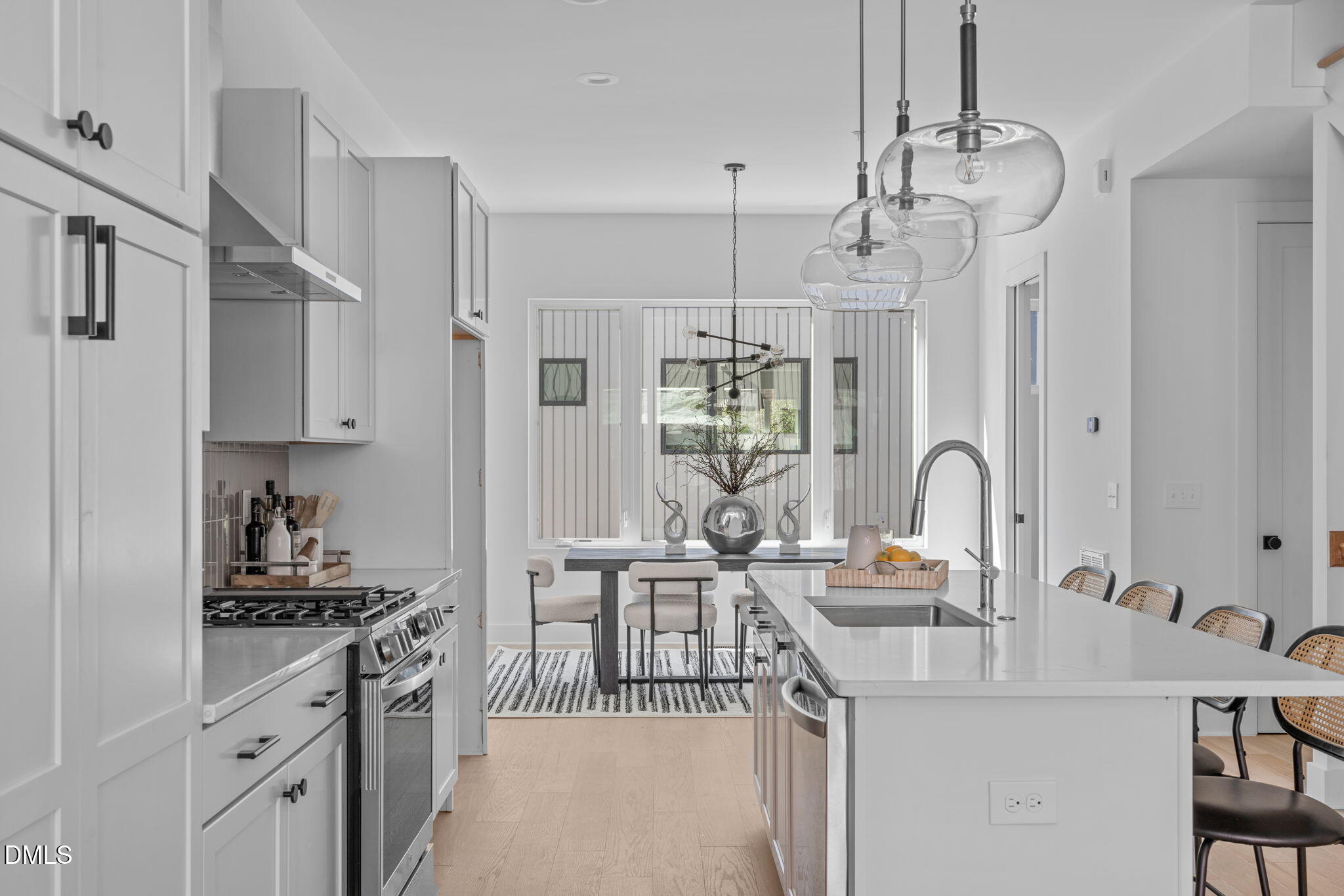 2004 Moody Durham, NC 27701 - Photo 5 of 43 a kitchen with kitchen island a white counter top space a sink stainless steel appliances and cabinets