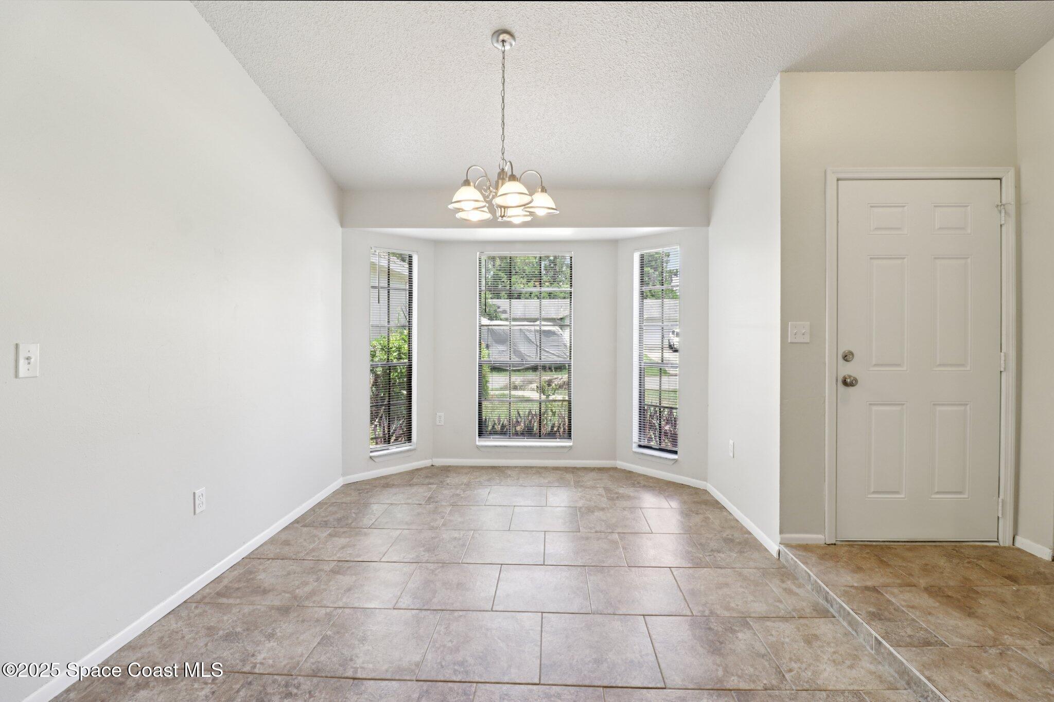 5215 Holden Road Cocoa, FL 32927 - Photo 12 of 34 a view of an empty room with a window