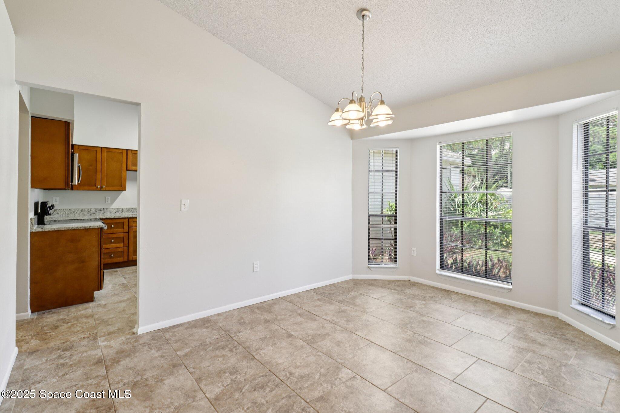 5215 Holden Road Cocoa, FL 32927 - Photo 14 of 34 a view of a kitchen with a sink and dishwasher cabinets