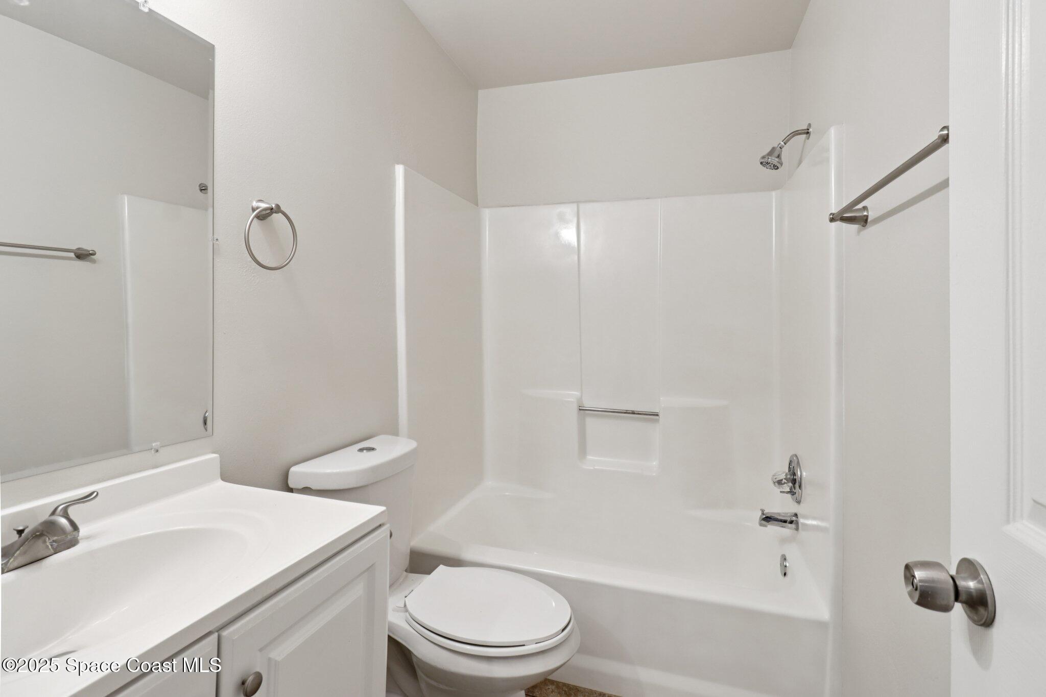 5215 Holden Road Cocoa, FL 32927 - Photo 23 of 34 a bathroom with a sink a toilet and shower
