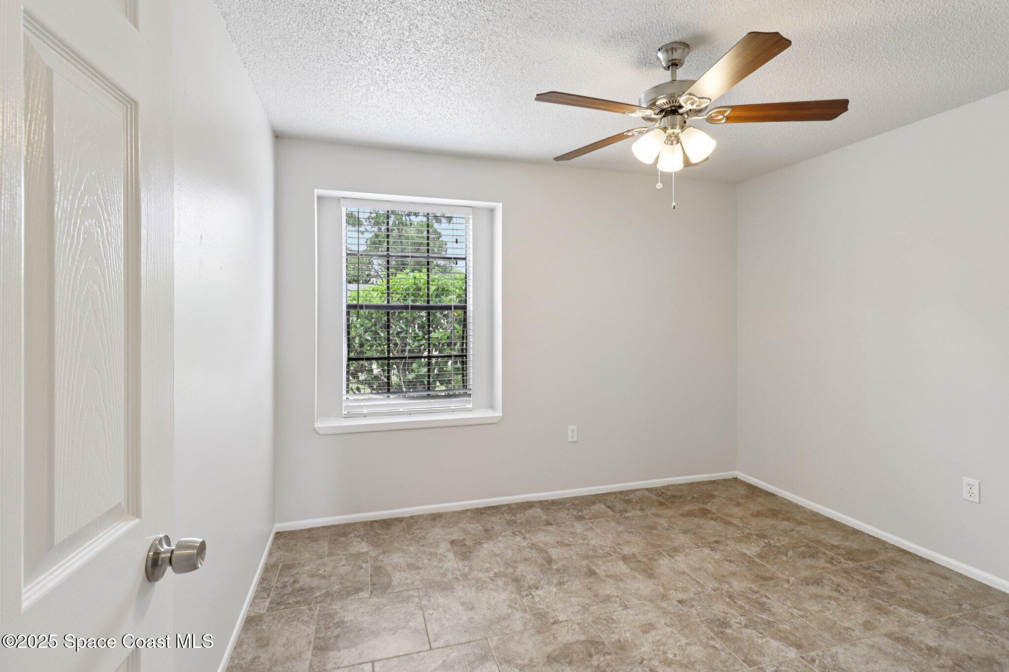5215 Holden Road Cocoa, FL 32927 - Photo 24 of 34 an empty room with windows and fan