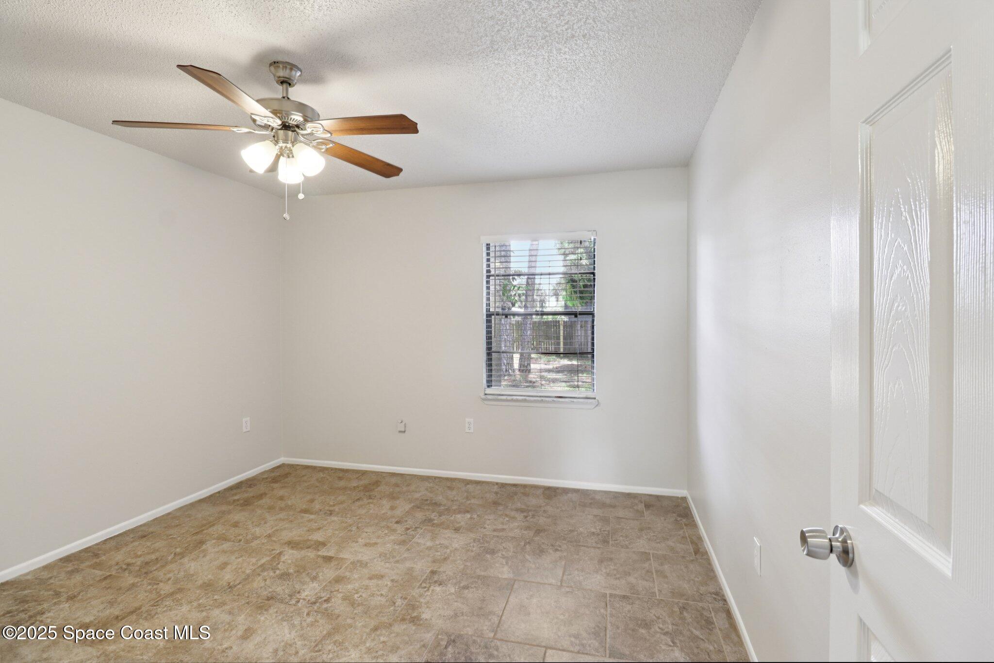 5215 Holden Road Cocoa, FL 32927 - Photo 26 of 34 a view of an empty room with a window
