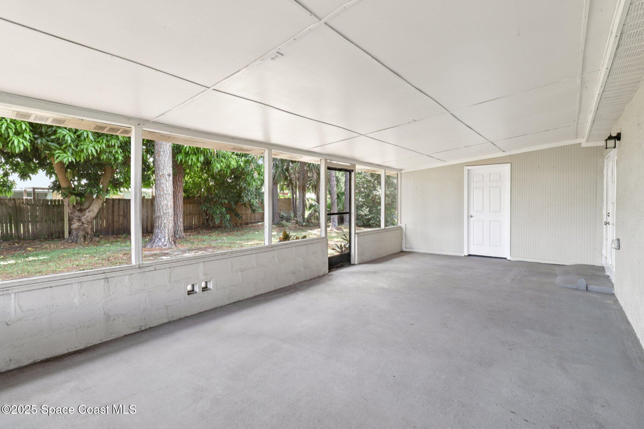 5215 Holden Road Cocoa, FL 32927 - Photo 29 of 34 a view of an empty room with a balcony and large windows