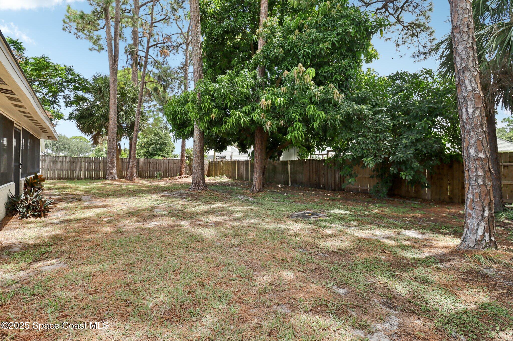 5215 Holden Road Cocoa, FL 32927 - Photo 31 of 34 a backyard of a house with lots of green space