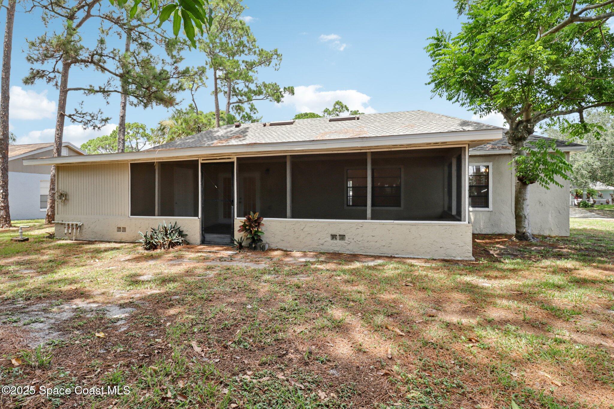 5215 Holden Road Cocoa, FL 32927 - Photo 33 of 34 a view of a house with backyard and porch