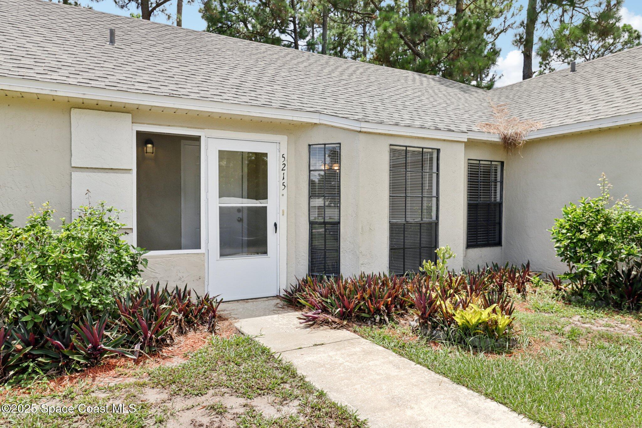 5215 Holden Road Cocoa, FL 32927 - Photo 4 of 34 front view of a house with a yard
