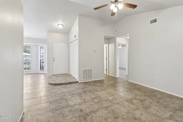 a view of empty room with a fan