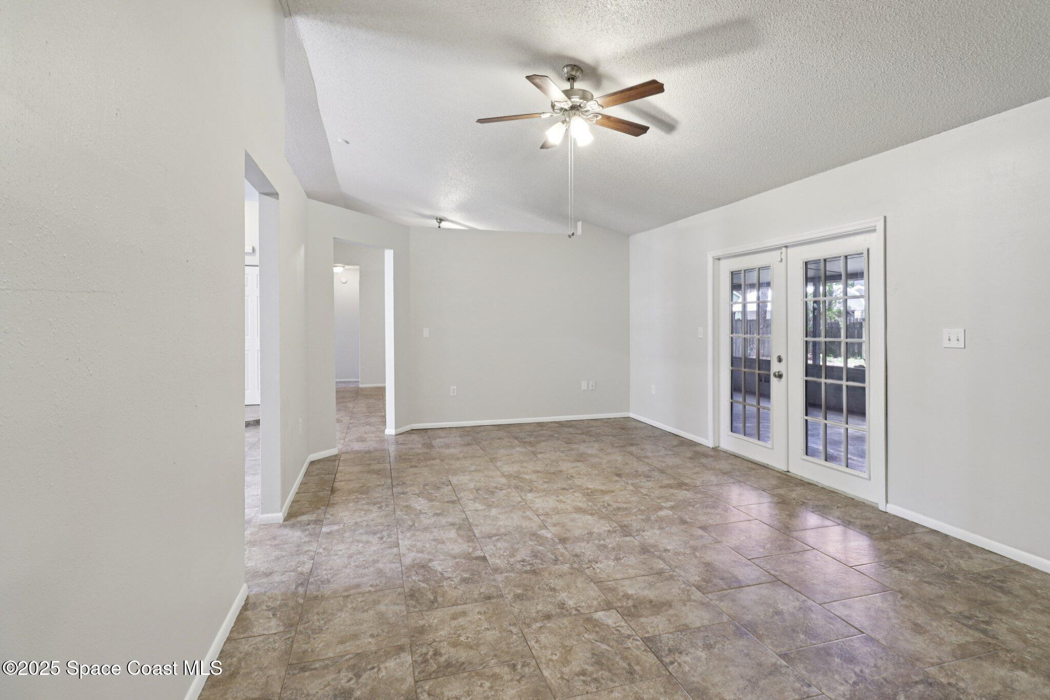 5215 Holden Road Cocoa, FL 32927 - Photo 9 of 34 a view of an empty room with a chandelier fan