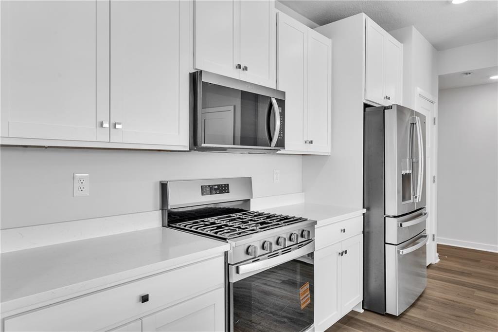 126 Scotland Lane Harmony, PA 16037 - Photo 13 of 43 a kitchen with stainless steel appliances white cabinets and a stove top oven