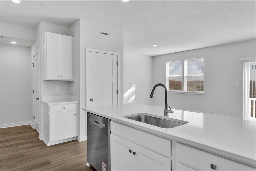 126 Scotland Lane Harmony, PA 16037 - Photo 14 of 43 a kitchen with stainless steel appliances a sink a window and wooden floor