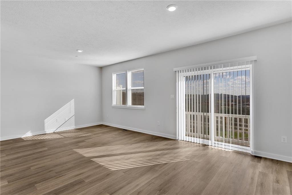 126 Scotland Lane Harmony, PA 16037 - Photo 17 of 43 a view of an empty room with wooden floor and a window