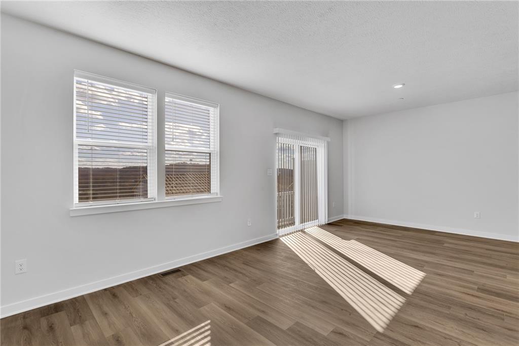 126 Scotland Lane Harmony, PA 16037 - Photo 19 of 43 a view of an empty room with wooden floor and a window