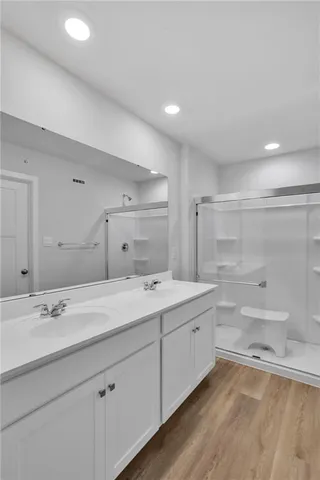 a bathroom with a double vanity sink mirror and