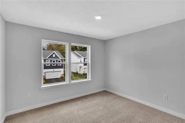 an empty room with windows and entrance