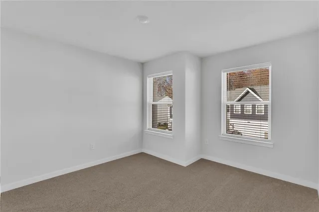 a view of an empty room with windows