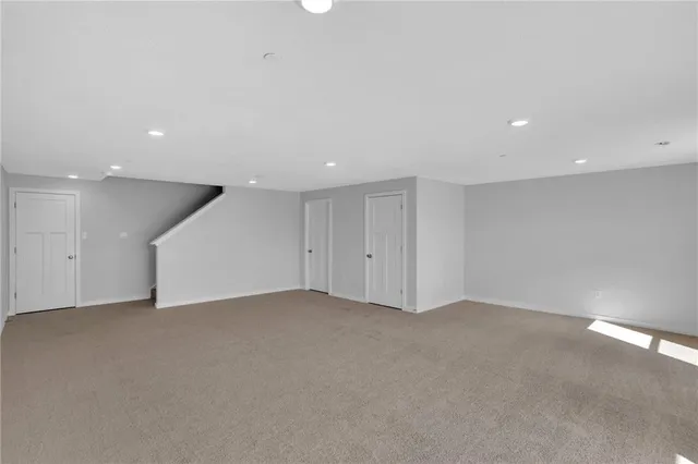 a view of an empty room with a kitchen