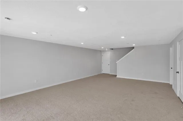 an empty room with a projector and white walls