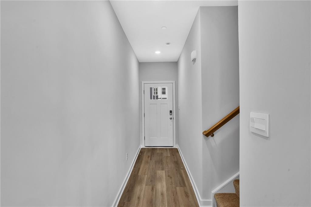 126 Scotland Lane Harmony, PA 16037 - Photo 4 of 43 a view of a hallway with wooden floor and staircase