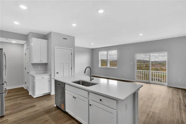 a kitchen with a sink stove and cabinets