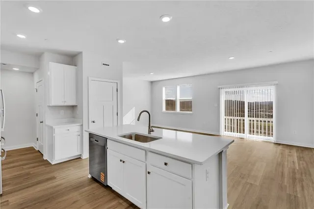 a kitchen with sink and cabinets