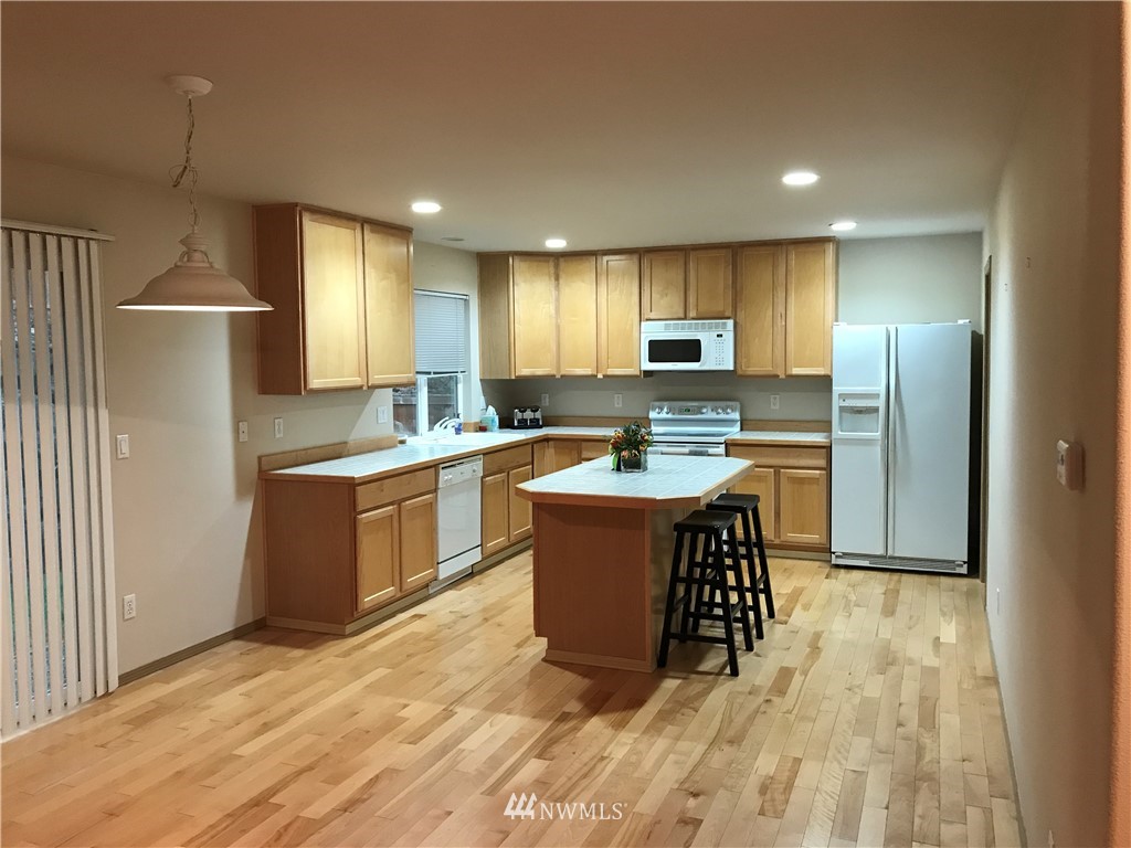 2226 Southeast 2nd Place Renton, WA 98056 - Photo 6 of 20 a kitchen with kitchen island a sink stainless steel appliances and cabinets